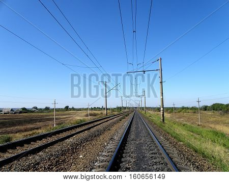 Double-track electrified railroad goes into the distance.