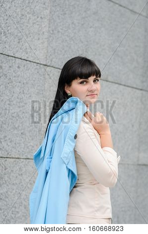 Long-haired Brunette In A White Suite With A Turquoise Coat