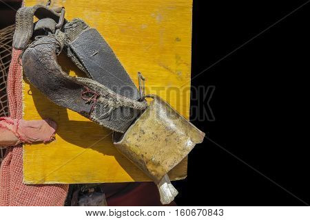 foreground of a cowbell with aged leather belt