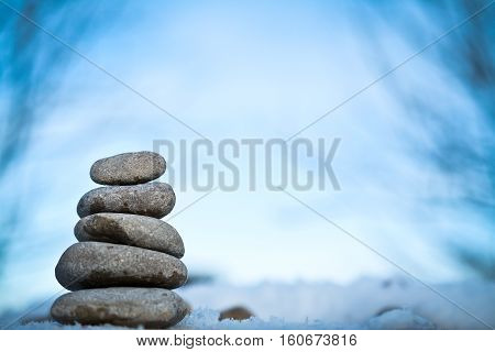 zen spa stones with blue sky in winter nature