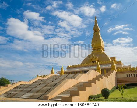 Gold Pagoda on blue sky background Roiet Thailand