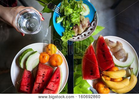 Plate with watermelon banana oranges and salad in restaurant in Thailand