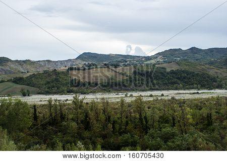 River between the hills through the valley