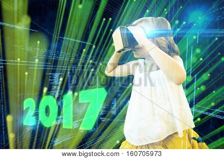 Girl wearing virtual reality simulator against digitally generated black and blue matrix