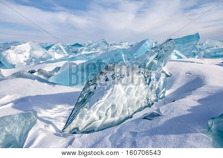 Beautiful blocks of blue natural ice on sky background