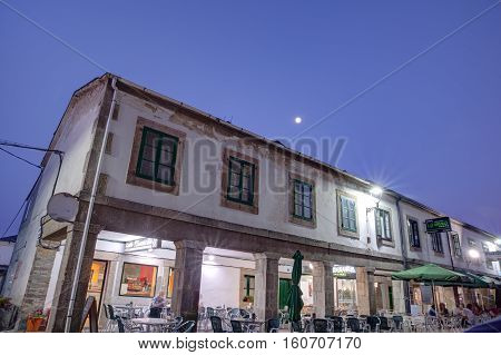 PORTOMARIN SPAIN - AUGUST 12: View of the building in the central street at sunset on August 12 2016