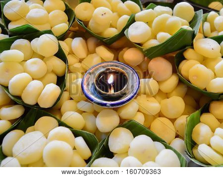 Waternut fruit in bamboo leaf with aroma candle.