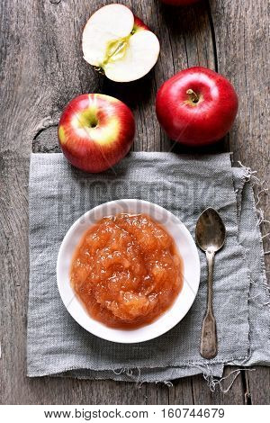 Apple jam and fresh fruits on wooden background top view