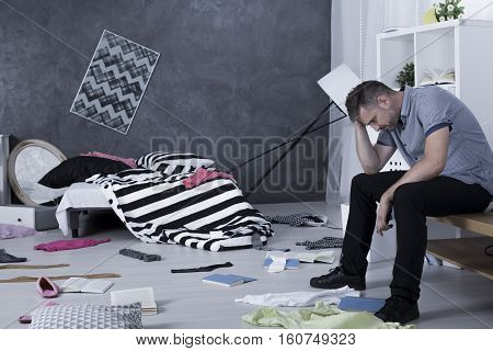 Sad Man Surrounded By Mess