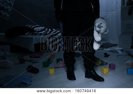 Burglar Holding A Teddy Bear