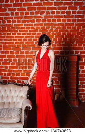 Portrait of Beautiful Sensual smilyng Woman in Fashion Red Dress. Christmas Sales and Shopping concept. Studio shot