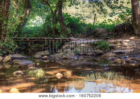 Little wooden bridge on the creek along the way of St. James