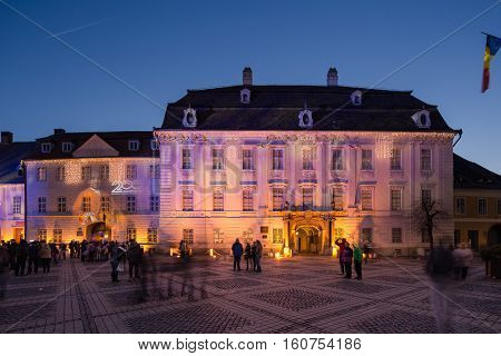 SIBIU ROMANIA - NOVEMBER 26th, 2016 - Brukenthal Museum in Sibiu, a famous baroque building from XVIIIth century in Transylvania Romania, by night in winter with Christmas decoration