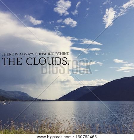 Inspirational quote.  Lake landscape with large white and grey storm cloud, blue sky mountains and calm lake in summer. Cloud reflection on water.   Instagram effects.