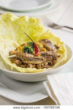 Fried anchovy fillets with garlic parsley and chili peppers