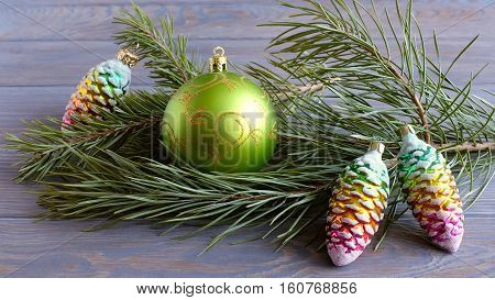 Christmas card with fir branches and green balls.