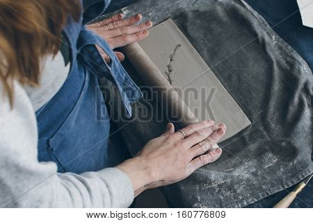 Ceramic artist working on a clay, small workshop