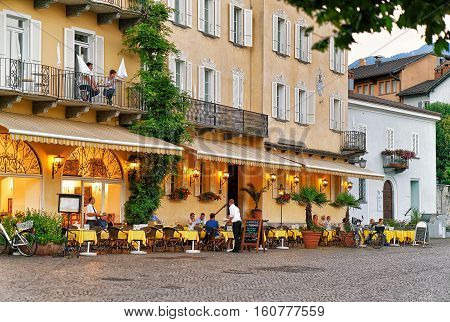 People Relaxing At Street Restaurant In Ascona In Swiss