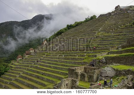 View Of Terraces Of Lost Inca City Of Machu Picchu. Low Clouds. Cusco Region,sacred Valley, Peru