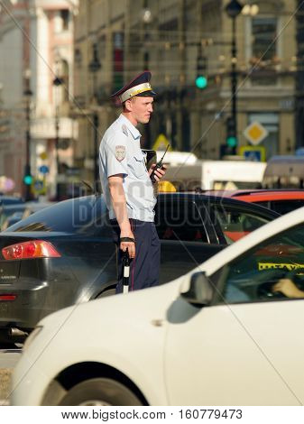 30.06.2016.Russia.Saint-Petersburg.Policeman regulates the movement of vehicles in the city.