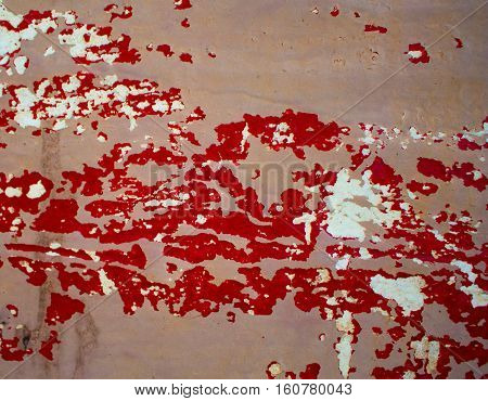 Rough texture with old paint stains. Grungy painted wood texture for backdrop. Red and beige scratched paints. Bright shabby background. Obsolete painted wood board. Distressed textured timber image
