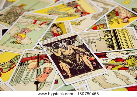 Moscow, Russia - December 4, 2016: Tarot card Devil with other cards. Rider-Waite tarot deck. Esoteric background