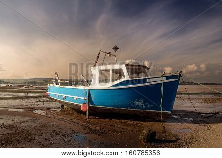 old fishing boat aground at low tide. River Exe. Devon. England