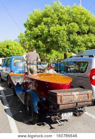 Ascona Switzerland - August 23 2016: Rolls Royce Retro car in the street of Ascona in Ticino Switzerland. With driver and passenger in the car