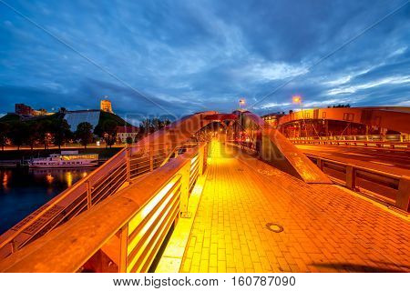 Night view on the illuminated bridge and castle hill in Vilnius, Lithuania