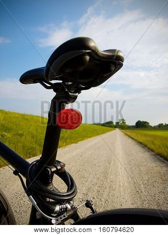 Bicycle saddle in the seat. Road in background
