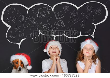 Little children and his puppy friend in Sante hat dreaming of the magic Christmas gifts. Merry Christmas concept.