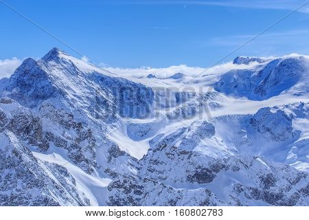 Alps, view from Mt. Titlis in winter. Titlis is a mountain located on the border between the Swiss cantons of Obwalden and Bern.