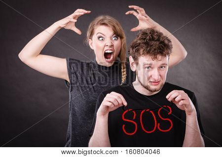 Young Couple With Broken Heart And Sos Word.