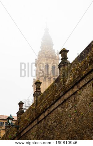 View of the belltower of the Santiago cathedral covered by fog Spain