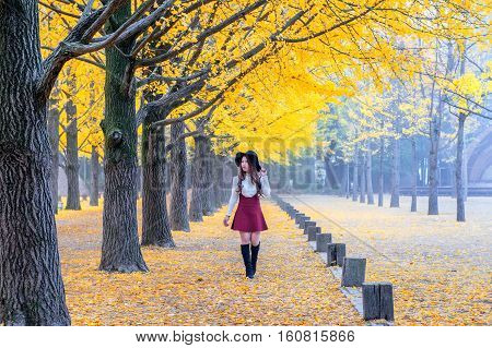 Beautiful Girl with Yellow Leaves in Nami Island Korea.