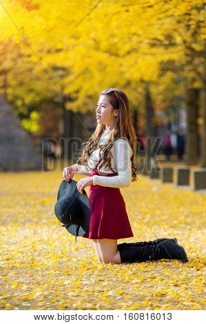 Beautiful Girl with Yellow Leaves in Nami Island Korea. Nami island in autumn.