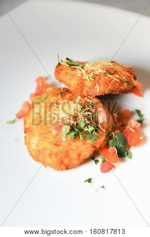 Indian savoury Vadai on white plate close up