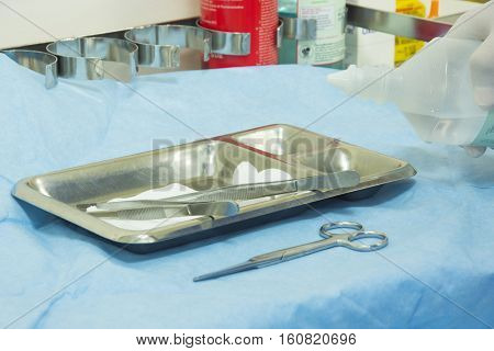 dressing wound set and hand pouring normal saline water