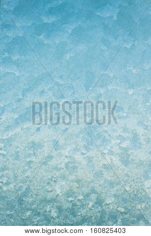 frost and ice patterns on windowglass coverd with ice