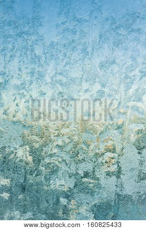 frost and ice patterns on windowglass coverd with ice