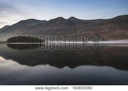 Beautiful Autumn Fall Landscape Image Of Crummock Water At Sunrise In Lake District England