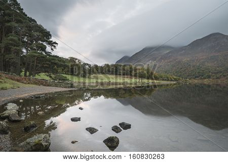 Beautiful Autumn Fall Landscape Image Of Crummock Water At Sunrise In Lake District England
