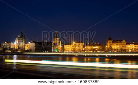 Night photo of Prague Old Town (Smetanovo Nabrezi) and Powder tower from the Vltava river Bohemia Czech Republic