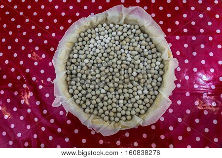 Baking Beans Lining A Flan Dish On Table Top.
