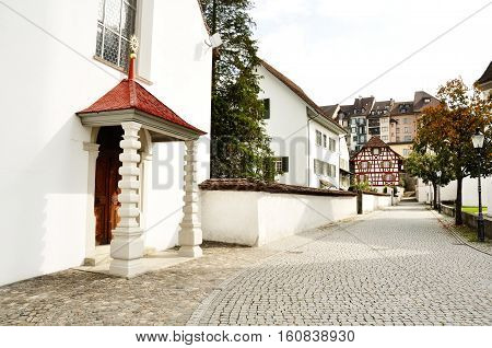 Church and characteristic cobblestone road in Bremgarten Aargau Switzerland