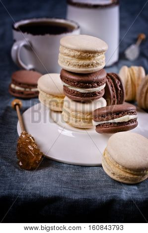 Brown and beige macaroon with light cream. Selective focus.