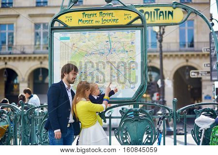 Family In Paris, Looking At Subway Map