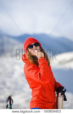 Girl Enjoys A Hygienic Lipstick In The Mountains.