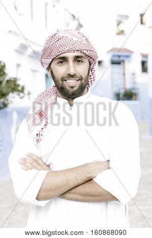 Young smiling handsome arabic man wearing traditional clothes