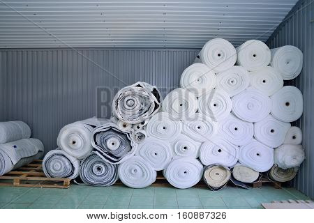 Sintepon. Insulation for clothing. Insulation material. The concept of sewing production. Warehouse tissues.